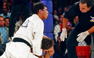 Close up of BJJ black belt with red tab being tied