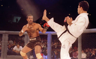 Royce Gracie blocks a kick from Dan Severn at UFC early mixed martial arts event